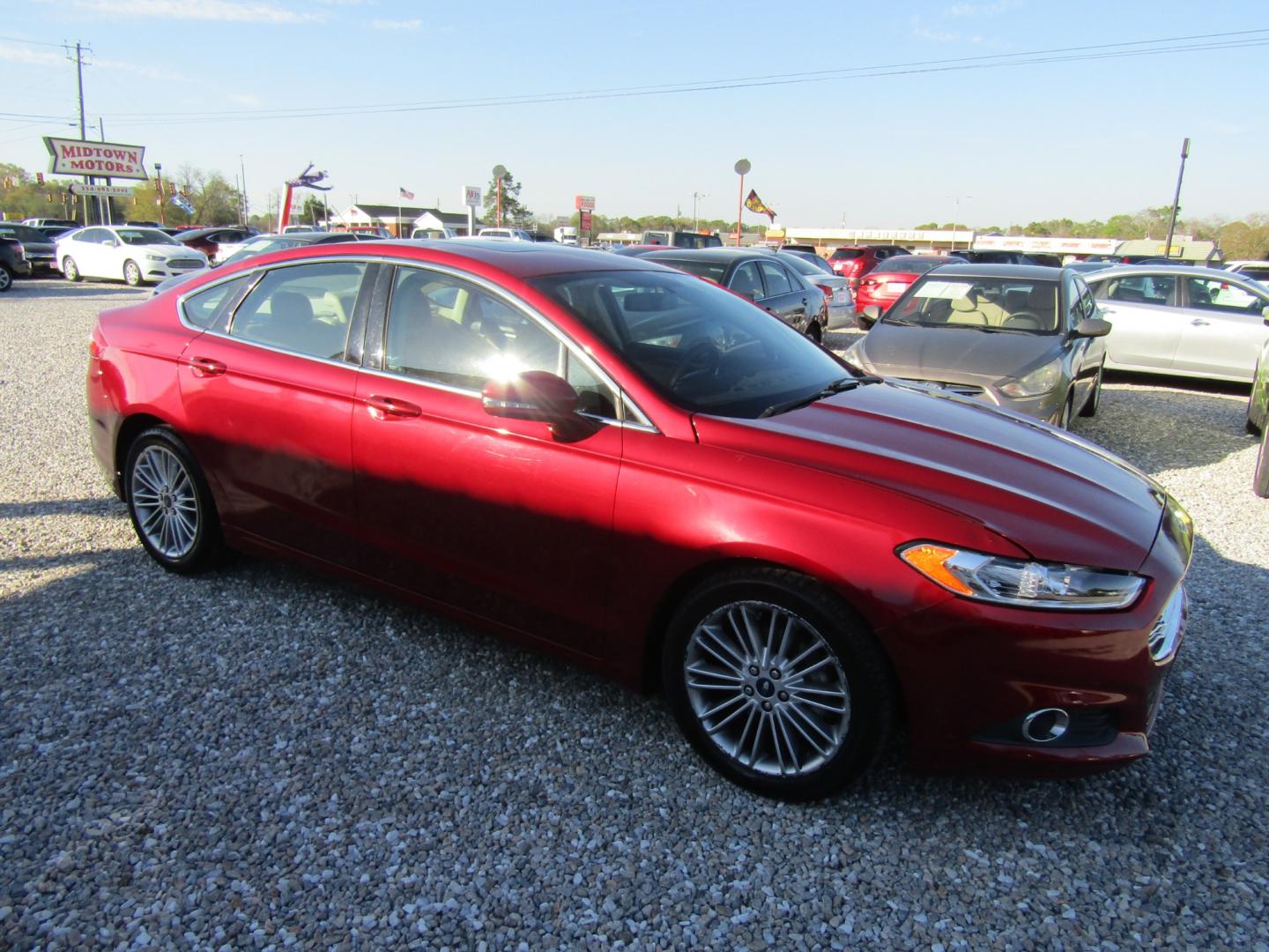 2015 Red Ford Fusion SE (3FA6P0HDXFR) with an 1.5L L4 DOHC 16V engine, Automatic transmission, located at 15016 S Hwy 231, Midland City, AL, 36350, (334) 983-3001, 31.306210, -85.495277 - Photo#0